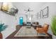 Bright and airy living room boasts wood floors, modern decor, and a vibrant front door at 1995 Meador Ave, Atlanta, GA 30315