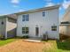 View of the home's exterior featuring a door to the backyard and gray vinyl siding at 509 Carlton Pointe Dr, Palmetto, GA 30268