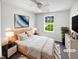 Cozy bedroom with ceiling fan, a bright window overlooking the lawn and neutral decor at 509 Carlton Pointe Dr, Palmetto, GA 30268