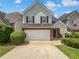 Charming two-story home features a two-car garage, brick accents, and a well-manicured lawn at 509 Carlton Pointe Dr, Palmetto, GA 30268