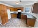 Functional kitchen with wood cabinets, dark appliances and countertops, ready for Gathering meals at 509 Carlton Pointe Dr, Palmetto, GA 30268
