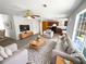 Staged living room featuring neutral furniture, a ceiling fan, and an open layout leading to the kitchen at 509 Carlton Pointe Dr, Palmetto, GA 30268