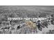 Black and white aerial view showing a property surrounded by trees with its border highlighted in yellow at 1585 Lake Dow Rd, Mcdonough, GA 30252