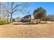 Spacious backyard with a well-maintained lawn and mature trees offering privacy and a tranquil outdoor space at 1585 Lake Dow Rd, Mcdonough, GA 30252