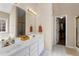 Bathroom features a double sink vanity, white tile floors, and a large mirror at 1585 Lake Dow Rd, Mcdonough, GA 30252