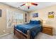 Cozy bedroom with ceiling fan, window view, and stylish decor at 1585 Lake Dow Rd, Mcdonough, GA 30252