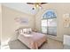Cozy bedroom features a vaulted ceiling, large window and a ceiling fan at 1585 Lake Dow Rd, Mcdonough, GA 30252