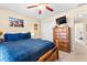 Bedroom with window view, ceiling fan, TV, and a dresser at 1585 Lake Dow Rd, Mcdonough, GA 30252