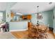 Charming dining area with hardwood floors, modern light fixture, and kitchen with warm wood cabinets at 1585 Lake Dow Rd, Mcdonough, GA 30252