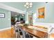 Open-concept dining area showcases a stylish table, chandelier, and seamless flow to the living area at 1585 Lake Dow Rd, Mcdonough, GA 30252