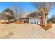 Spacious driveway and exterior view of the home, adjacent to a basketball court at 1585 Lake Dow Rd, Mcdonough, GA 30252