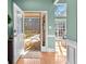 Inviting entryway boasts hardwood floors, an open door, and an abundance of natural light streaming through large windows at 1585 Lake Dow Rd, Mcdonough, GA 30252
