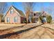 Charming brick home featuring manicured landscaping and inviting entrance at 1585 Lake Dow Rd, Mcdonough, GA 30252