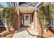 Inviting front porch of a brick home featuring decorated decor at 1585 Lake Dow Rd, Mcdonough, GA 30252