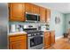 Well-lit kitchen features stainless steel appliances, wooden cabinetry, and white countertops at 1585 Lake Dow Rd, Mcdonough, GA 30252