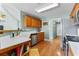 Spacious kitchen area boasts hardwood floors, modern appliances, and light-blue wall paint at 1585 Lake Dow Rd, Mcdonough, GA 30252