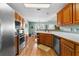 Well-equipped kitchen with stainless steel appliances, ample counter space, wooden cabinetry, and hardwood floors at 1585 Lake Dow Rd, Mcdonough, GA 30252