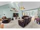 Open living area with a fireplace, TV, multiple seating options, and seamless transition to the dining area at 1585 Lake Dow Rd, Mcdonough, GA 30252