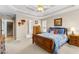 Spacious bedroom features a tray ceiling, comfortable carpet, and access to the staircase at 1585 Lake Dow Rd, Mcdonough, GA 30252
