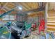 Unfinished basement with a Kawasaki mule, golf carts and a staircase at 604 Clearwater Ct, Mcdonough, GA 30252