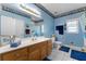 Charming bathroom with blue walls, decorative border, and a well-lit vanity at 604 Clearwater Ct, Mcdonough, GA 30252