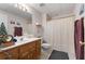 Standard bathroom features a wood vanity, large mirror, shower with curtain, and neutral finishes at 604 Clearwater Ct, Mcdonough, GA 30252