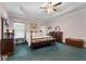 Spacious bedroom features a trey ceiling, ceiling fan and wide window for plenty of natural light at 604 Clearwater Ct, Mcdonough, GA 30252
