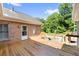 Wooden deck attached to brick home with an outdoor staircase and railing at 604 Clearwater Ct, Mcdonough, GA 30252