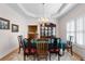 Traditional dining room with chandelier, tray ceilings, hutch, and wood table at 604 Clearwater Ct, Mcdonough, GA 30252