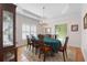 Traditional dining room with chandelier, tray ceilings, hutch, and long wood table at 604 Clearwater Ct, Mcdonough, GA 30252