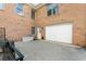 Brick home exterior with a white garage door and concrete driveway at 604 Clearwater Ct, Mcdonough, GA 30252