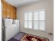 Functional laundry room with washer, dryer, storage cabinets, and window at 604 Clearwater Ct, Mcdonough, GA 30252