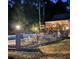 Backyard with in-ground pool, patio furniture, and an upper deck at night at 604 Clearwater Ct, Mcdonough, GA 30252
