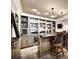Finished basement bar with custom cabinetry, bar seating, and modern lighting fixtures at 6265 Lake Windsor Pkwy, Buford, GA 30518
