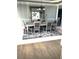 Elegant dining room featuring a large mirror, modern chandelier, and a stylish table set with six chairs at 6265 Lake Windsor Pkwy, Buford, GA 30518