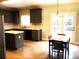 Spacious kitchen with granite countertops, stainless steel appliances, and a dining area leading to the outdoors at 6265 Lake Windsor Pkwy, Buford, GA 30518