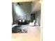 Bright living room with a fireplace, modern decor, tall ceiling, and large windows for ample natural light at 6265 Lake Windsor Pkwy, Buford, GA 30518