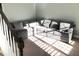 Bright and cozy living room with a large sectional couch with sunlight streaming through the window at 6265 Lake Windsor Pkwy, Buford, GA 30518