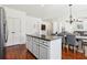 Kitchen island featuring granite countertops and custom cabinets, with dining area and living room in view at 4316 Constellation Blvd, Snellville, GA 30039