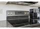 Close-up of a black stovetop with stainless steel knobs and a white tile backsplash at 4316 Constellation Blvd, Snellville, GA 30039