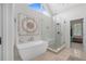 Luxurious bathroom boasts a soaking tub, glass-enclosed shower, and modern fixtures at 44 Kingsford Xing, Acworth, GA 30101