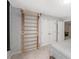 A bright bedroom features a wooden climbing frame and a view into a dining space at 44 Kingsford Xing, Acworth, GA 30101