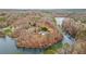 Aerial view of a home on a private lake surrounded by woods at 8160 Stone Hill Rd, Cumming, GA 30028