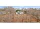 Aerial view of a two-story home surrounded by woods at 8160 Stone Hill Rd, Cumming, GA 30028