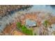 Aerial view of a beautiful single Gathering home surrounded by mature trees with a private lake at 8160 Stone Hill Rd, Cumming, GA 30028