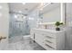 Modern bathroom featuring glass shower, beautiful tile, sleek vanity, and stylish lighting at 8160 Stone Hill Rd, Cumming, GA 30028