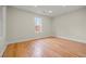 Bright bedroom featuring hardwood floors, natural light from a window, and recessed lighting at 8160 Stone Hill Rd, Cumming, GA 30028