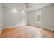 Bright bedroom featuring hardwood floors, natural light from a window, and a ceiling fan at 8160 Stone Hill Rd, Cumming, GA 30028