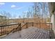 Spacious wooden deck overlooking a serene lake surrounded by trees, perfect for outdoor relaxation at 8160 Stone Hill Rd, Cumming, GA 30028