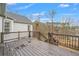 View of home's deck overlooking waterfront, with wooden railing and stairs at 8160 Stone Hill Rd, Cumming, GA 30028